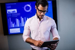 Serious Data Scientist Using Tablet Computer