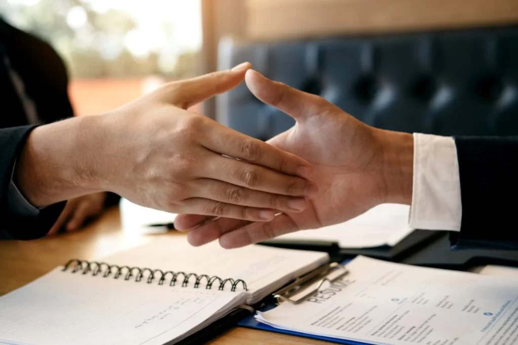 Job Seeker And Interviewer Shaking Hands To Signify Job Search Success E1634708291899