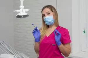 Dental Assistant Holding Dental Tools