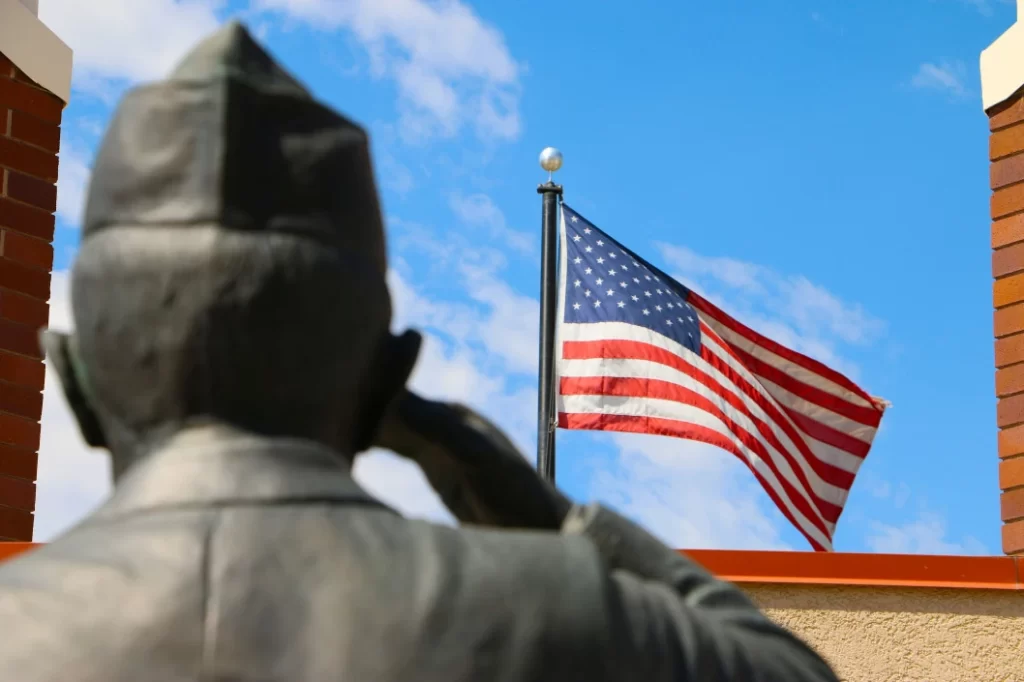 Statue Of Soldier Saluting The American Flag