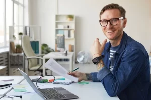 Web Developer Smiling Holding Document