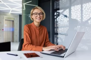 An Administrative Assistant Happily Engaged With Her Work