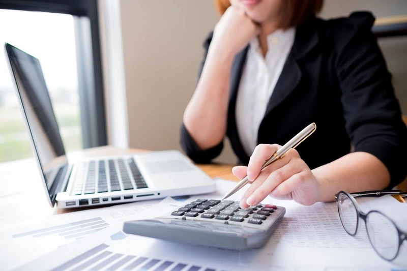 A Female Accountant Viewing A Chief Accounting Officer Resume Example On Her Laptop