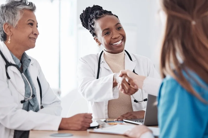 A Nurse Confidently Impressing A Group Of Professional Doctors During A Successful Job Interview