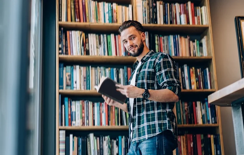 A Portrait Of A Man Spending His Day Productively By Reading Books