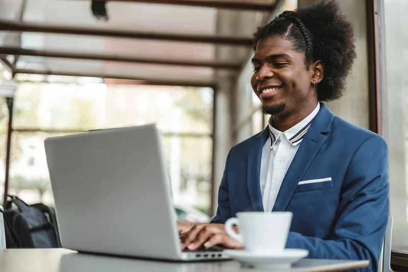 A Young Professional Writing His Resume That Showcases His Business Acumen