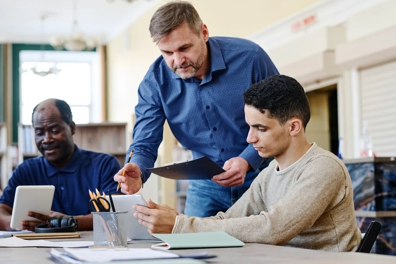 An Academic Advisor Offering Hands On Guidance To An Aspiring Intern