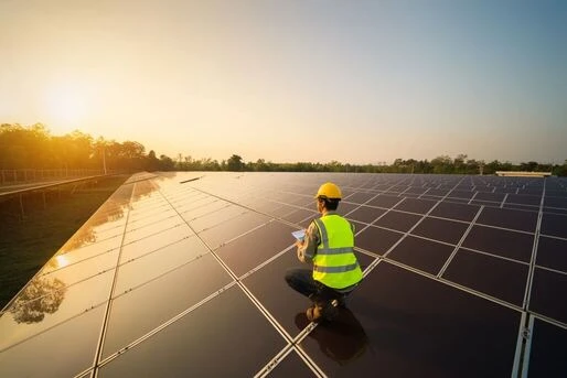 Engineer Working On Solar Panels On The Roof