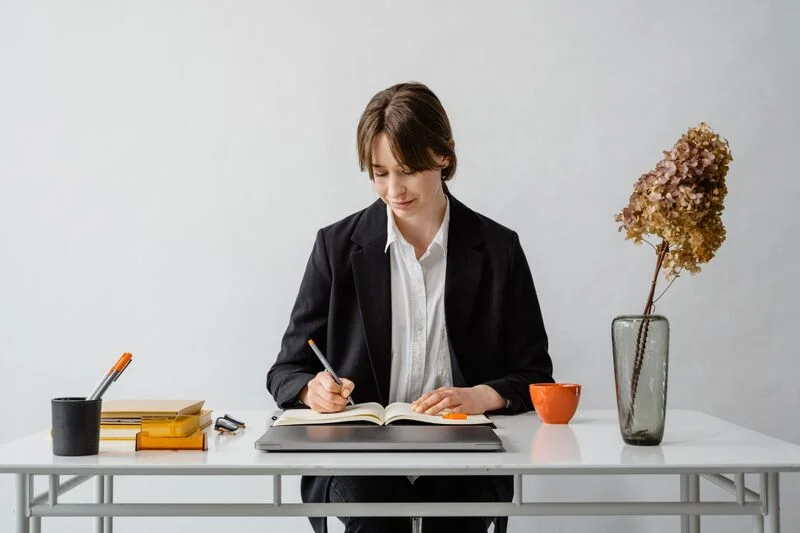 Man In Black Blazer Sitting At The Work Desk