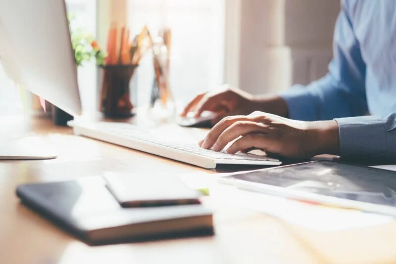 Man Using Computer To Explain Employment Gaps On His Cover Letter E1643013631749