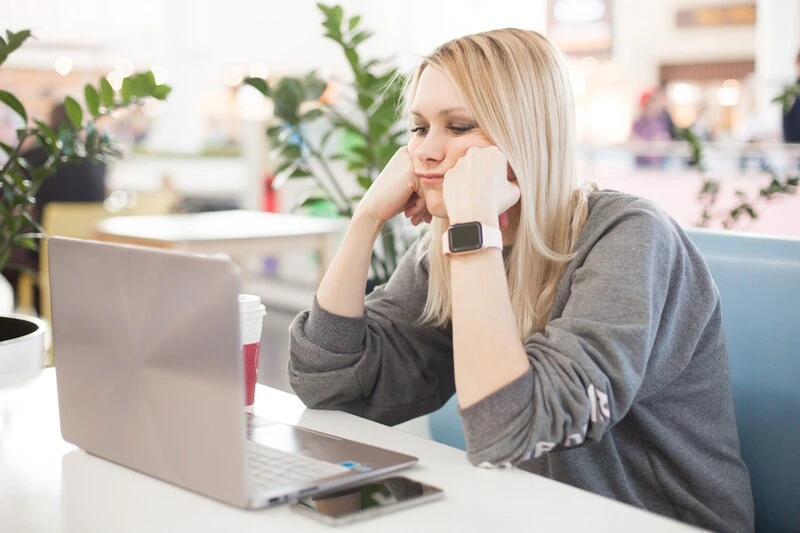 Nurse Practitioner Thinking On What To Include On Her Resume Uploaded In Her Laptop