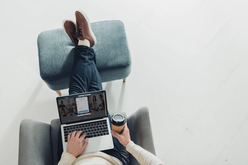 Top View Of Man Holding Paper Cup And Using Linkedin On Laptop 1024X683 1