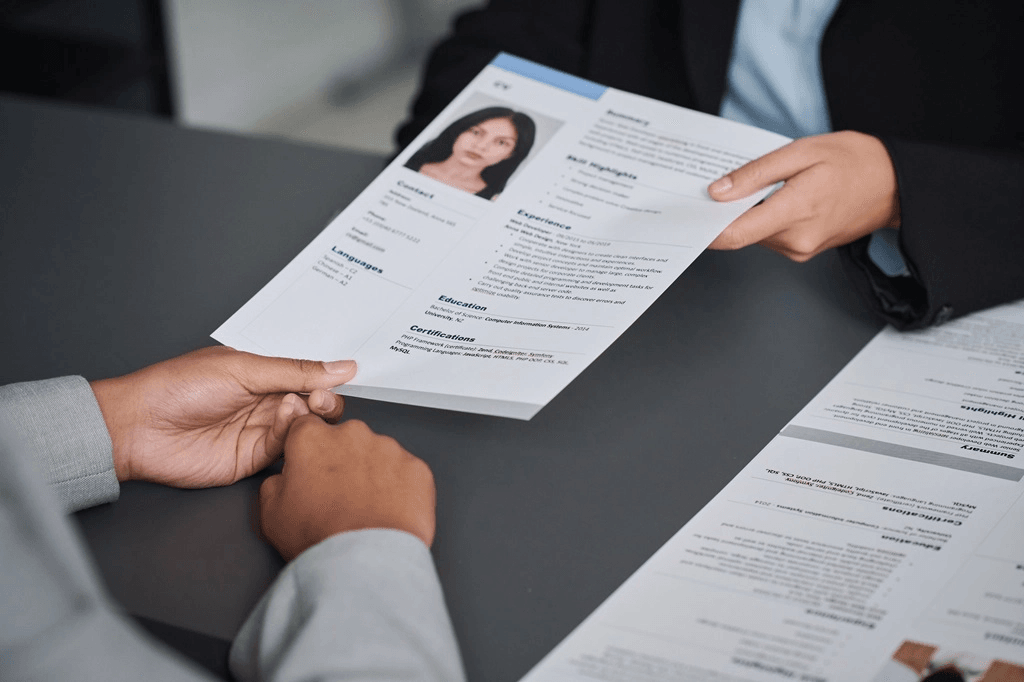 Applicant Submitting Her Resume To An Employer