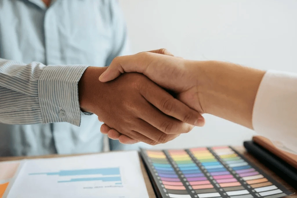 Newly Hired Graphic Designer Shaking Hands With The Employer
