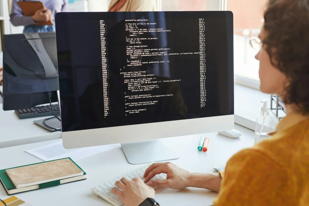 Software Engineer Writing Code At Computer 1024X682 1