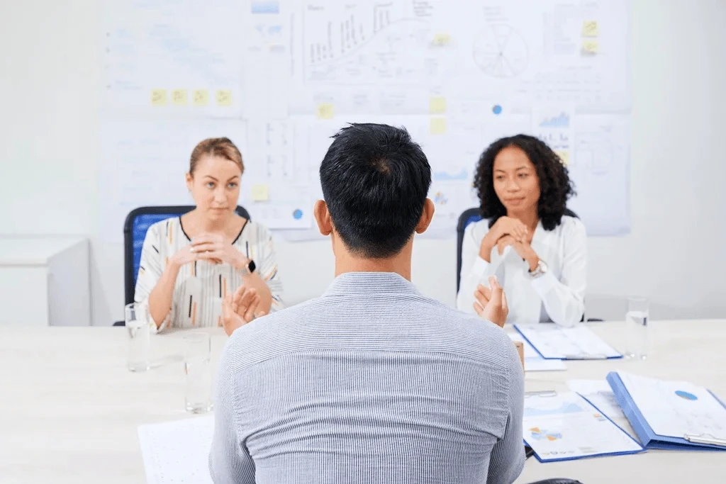 A Male Professional Answering Behavioral Questions In A Job Interview