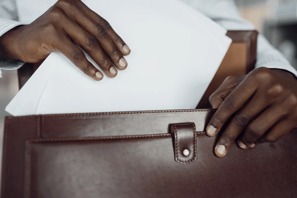 An Applicant Inserting His Portfolio Inside His Leather Briefcase