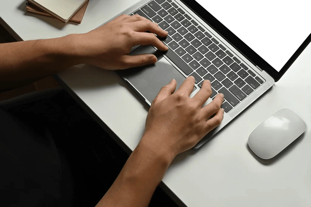 An Employee Typing To Whom It May Concern Letter On His Laptop