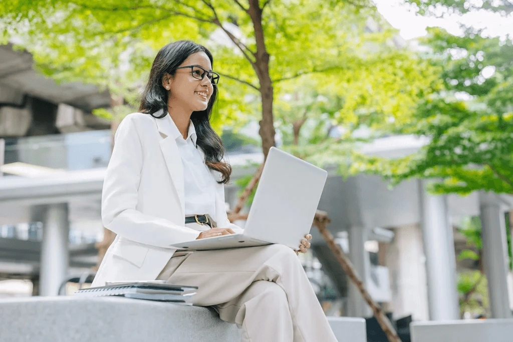 Career Woman Discovering More Of Her Career On Her Laptop During Her Break