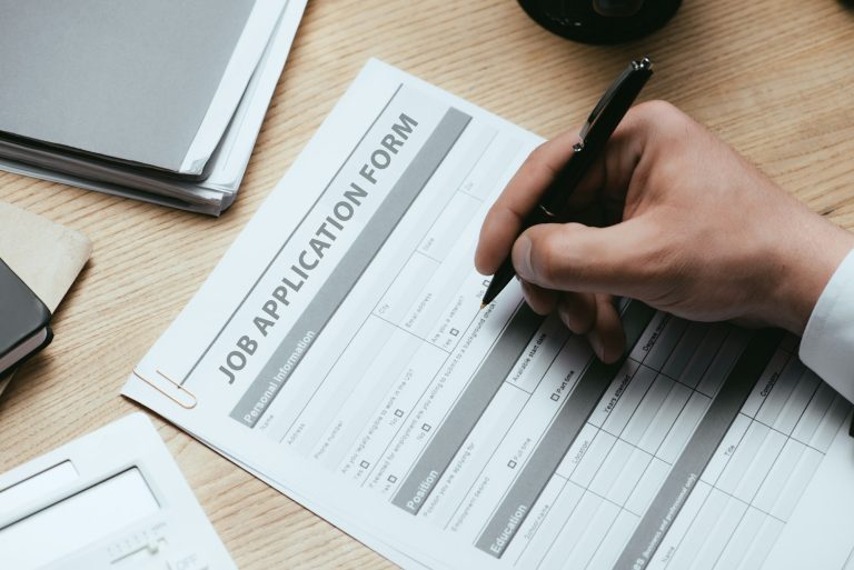 cropped view of man filling in Job Application Form Employment Career Concept