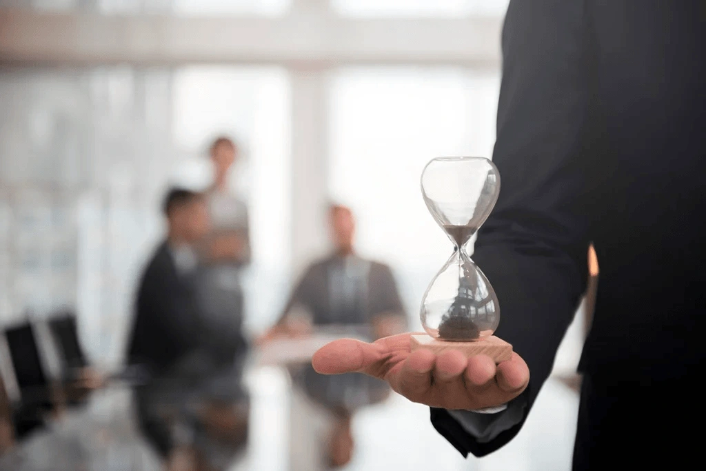 Employee Holding An Hourglass Depicting Mastery Of Time Management