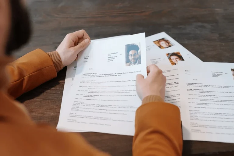 hiring manager scanning through different resumes from applicants