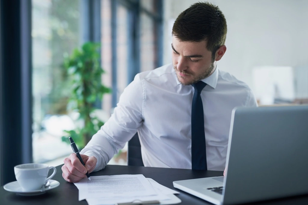 Male Recruiter Writing Down Clear Job Descriptions