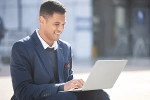 Professional Optimizing His Linkedin Profile Using His Laptop