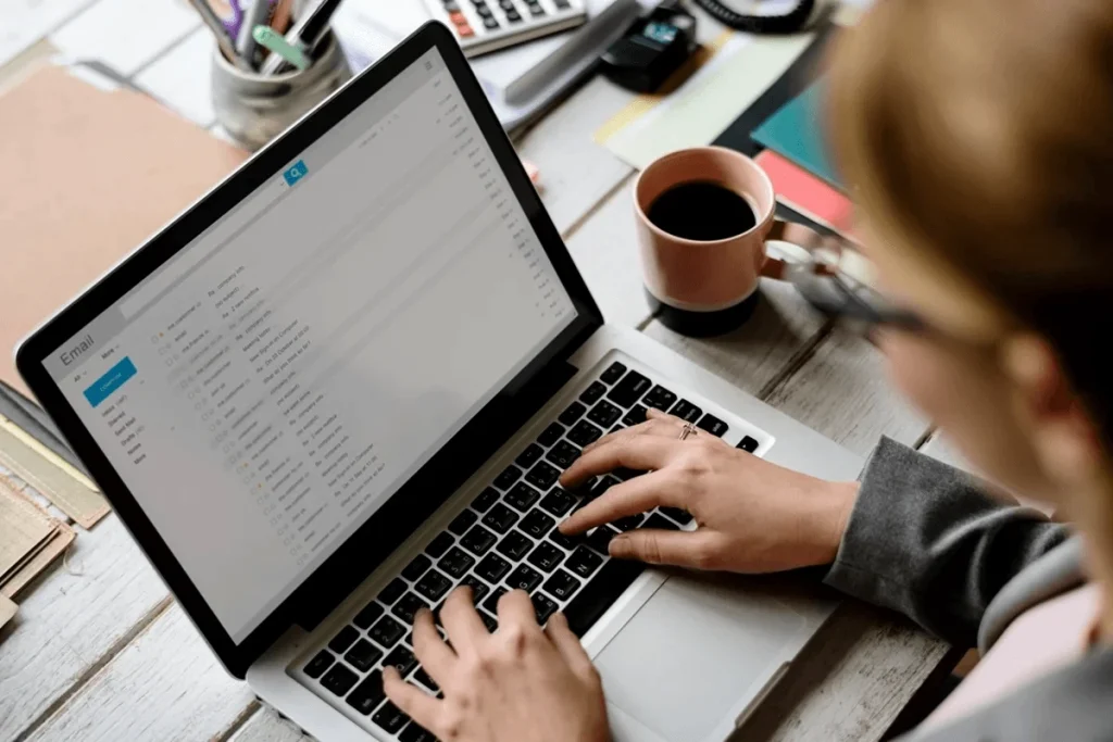 Professional Sending An Email Using Her Laptop