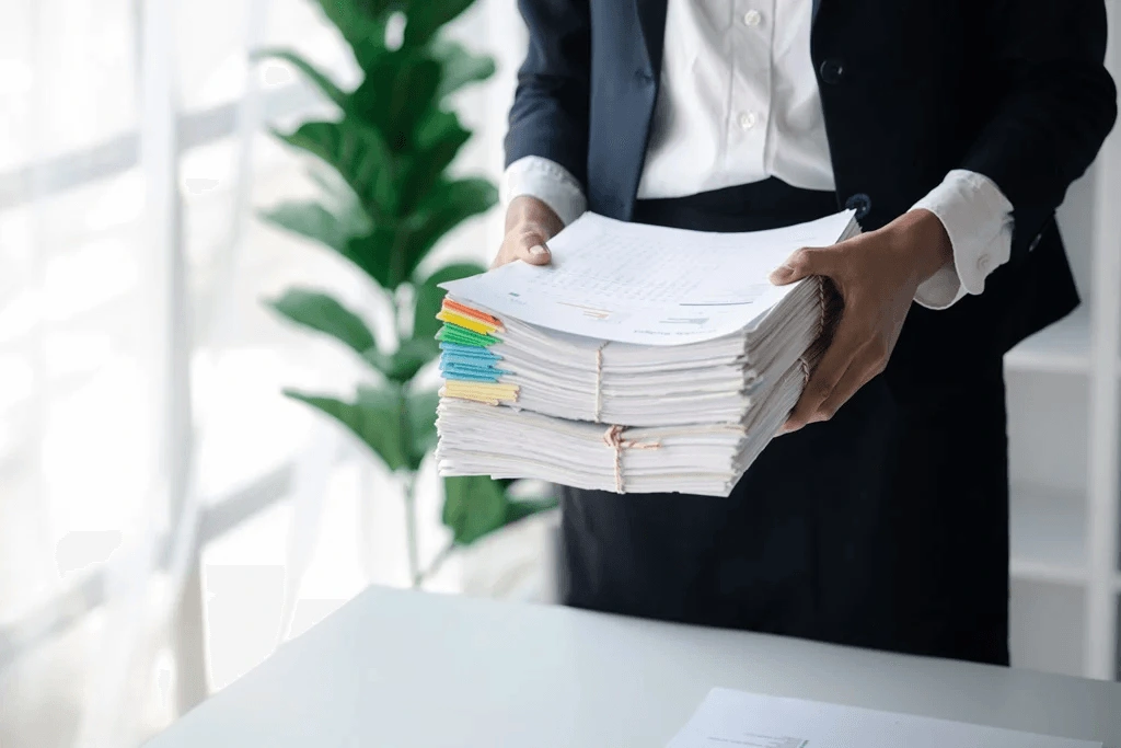 Recruiter Holding A Pile Of Applicants Documents