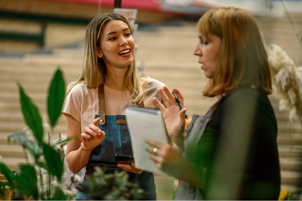 Two Business Women Chatting Happily About Career Experiences