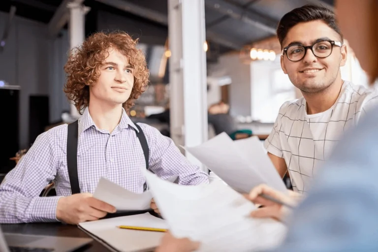 two new employees in a meeting with their supervisor regarding career assessment