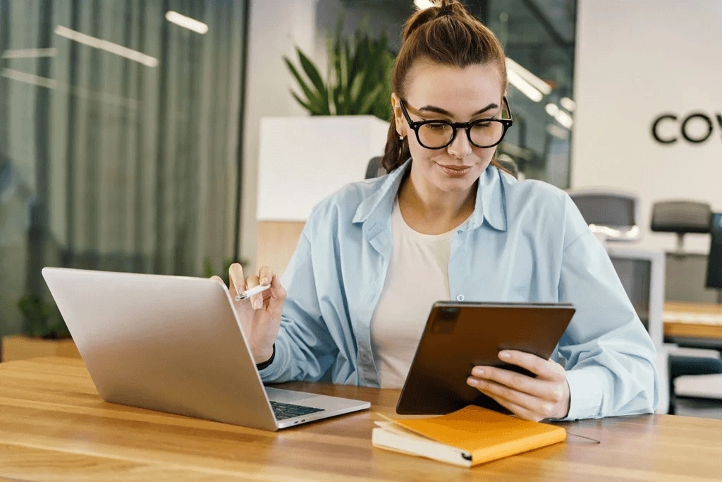 Woman With Dual Career Working On Her Laptop And Tablet