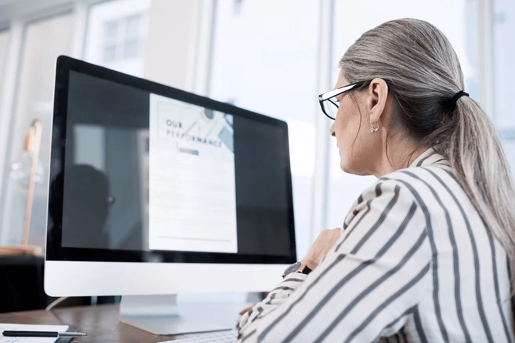 Career Woman Reading Mechanics Before Using -Professional Development Skill Identifier On Desktop