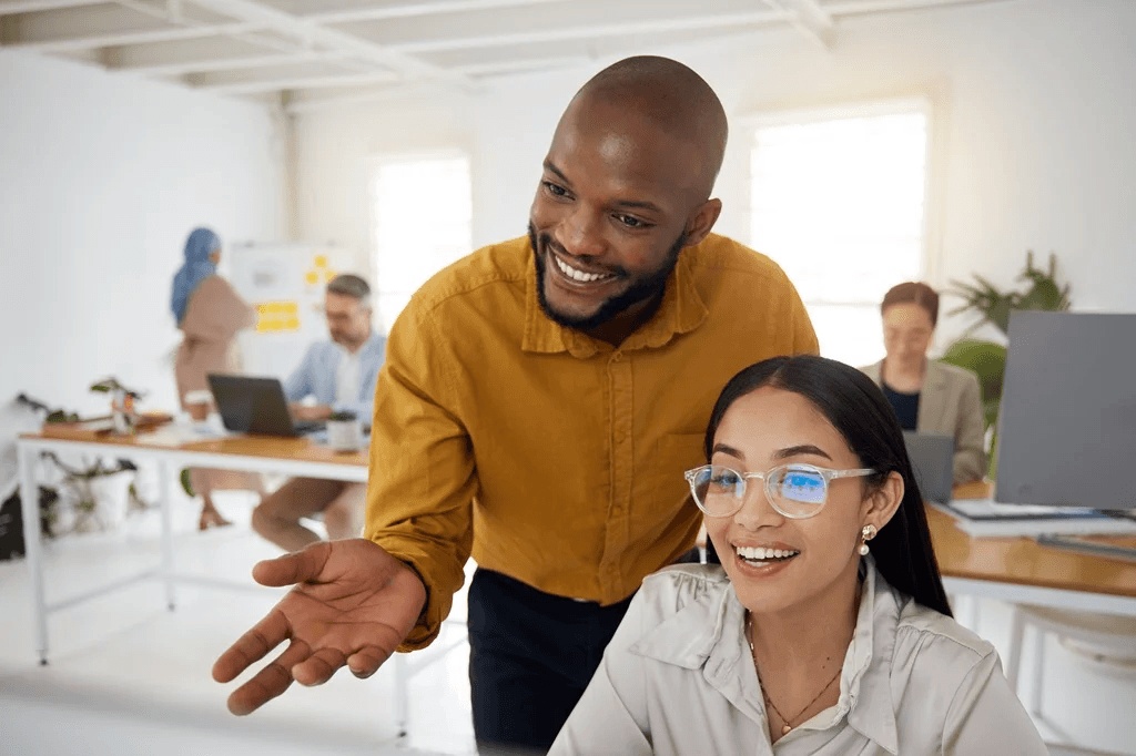 Female Employee Being Mentored By Her Supervisor