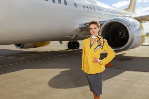 flight attendant in front of a commercial airplane