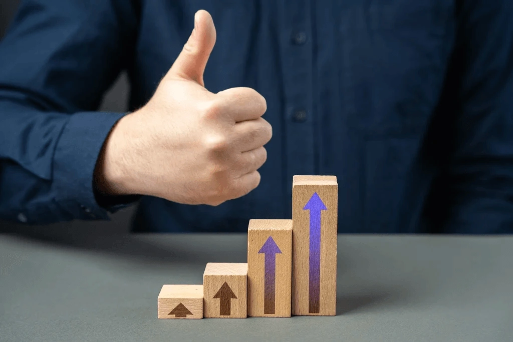 Man Shows A Thumbs Up From A Consistent Career Growth