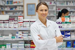 Portrait Of An Attractive Young Pharmacist Standing In Front Of Shelves