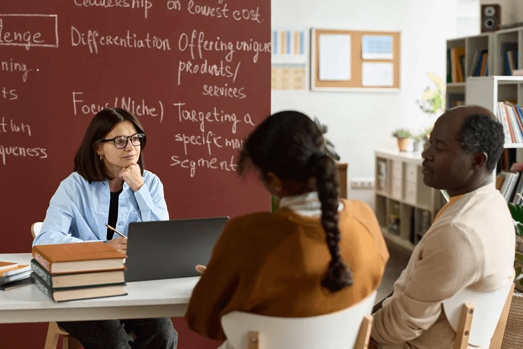 Teacher Collaborating With Students Parents