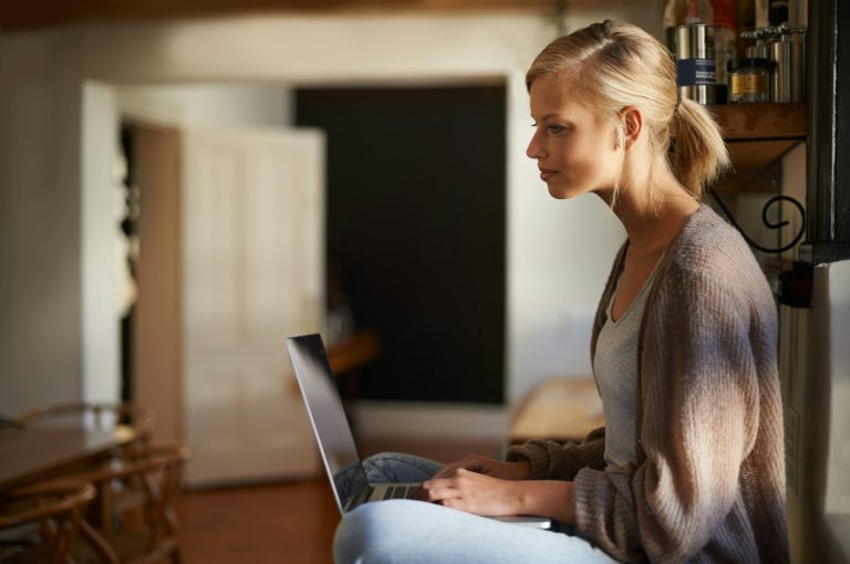 Woman optimizing her LinkedIn Profile in a laptop