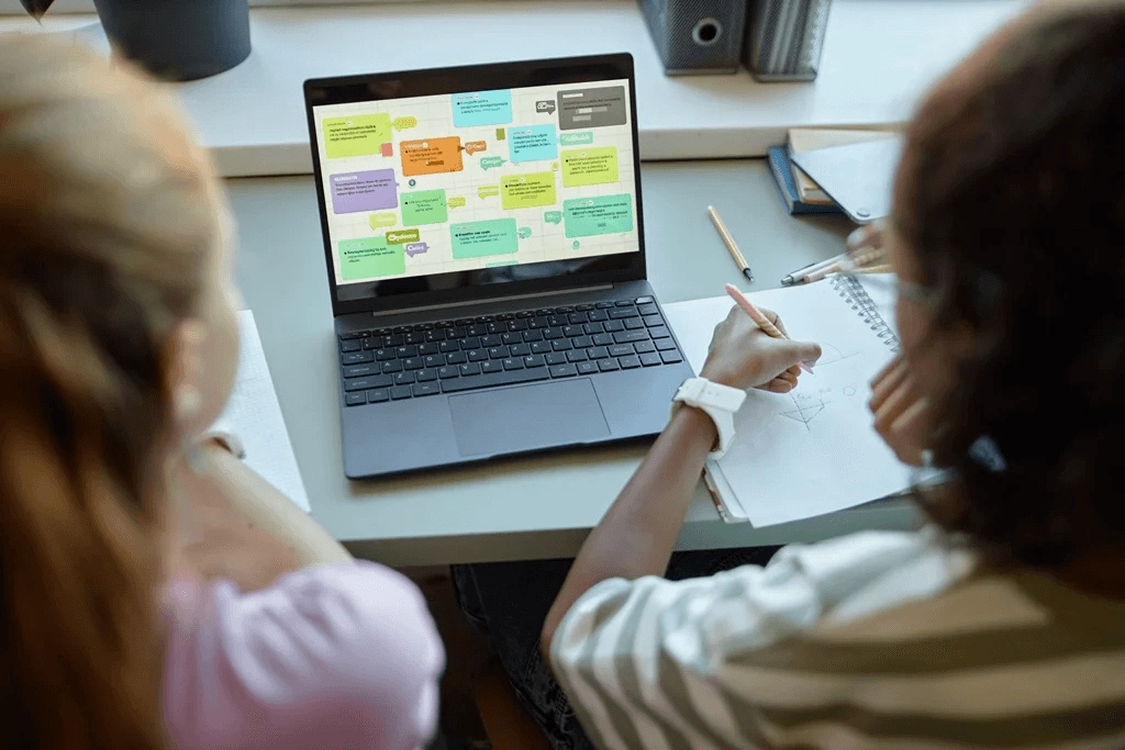 Two Female Employees Using Cutting Edge Career Mapping Tools