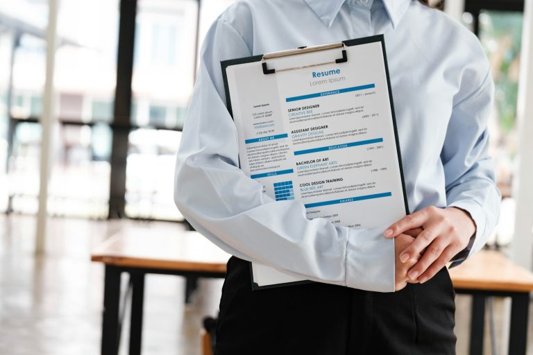 Close-Up of Job-seeker holding a Resume.