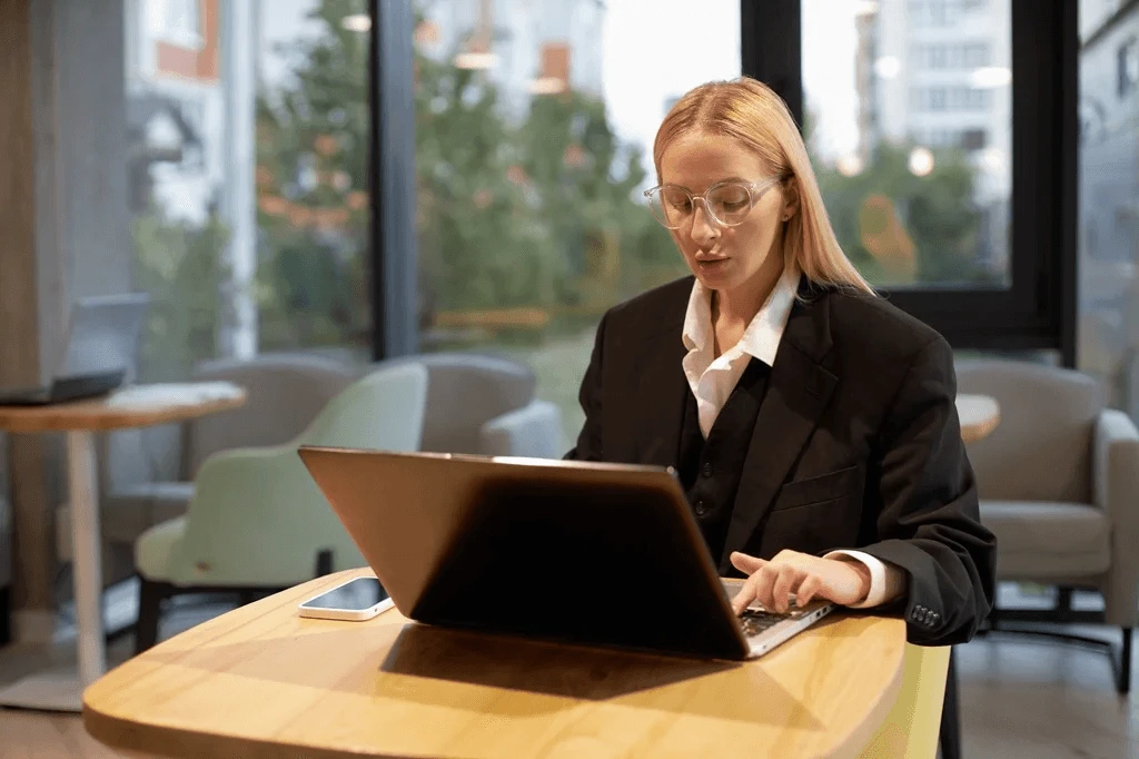 Employee Browsing Her Laptop To Find Her Linkedin Public Profile