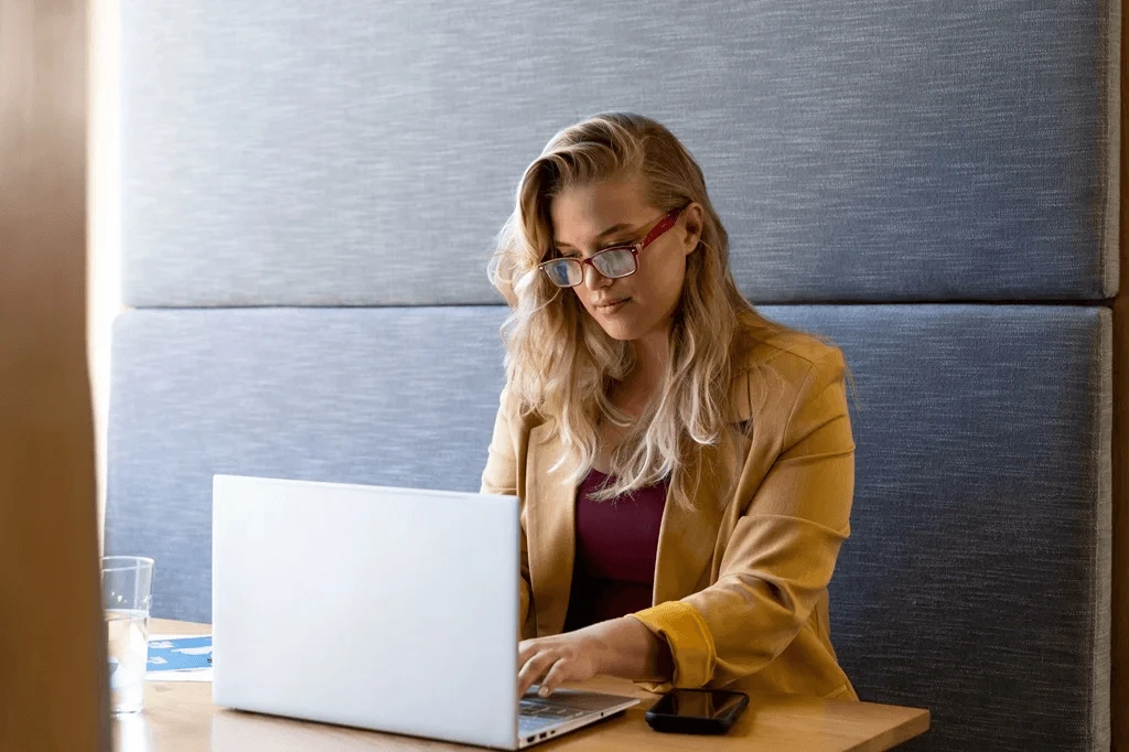 Female Professional Using Her Laptop To Optimize Her Linkedin Profile