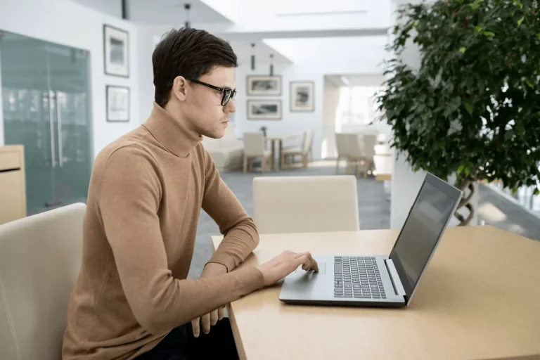 professional trying to find his LinkedIn public profile link using a laptop