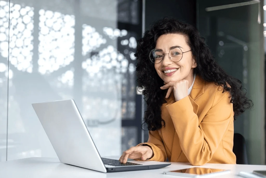 Professional Updating Her Linkedin Profile Using Her Laptop