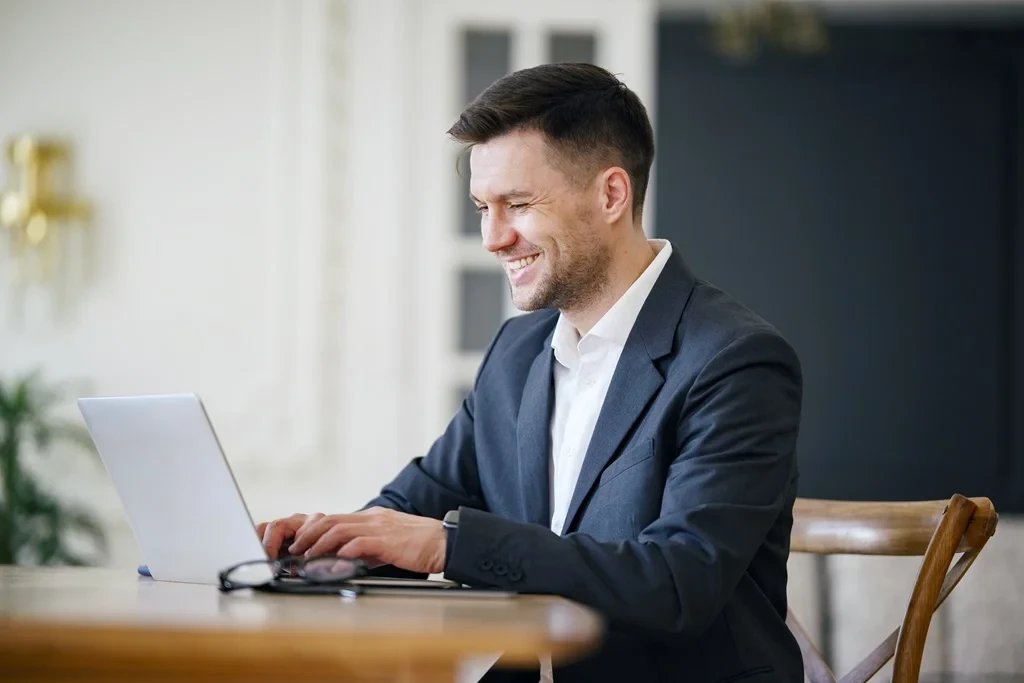 Professional Using His Laptop In Adding A Video To Linkedin