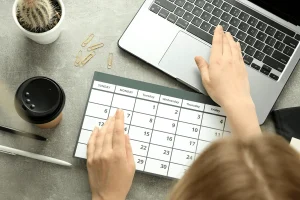 Employee Checking Calendar To Align Tasks With Dupont Work Schedule Shifts