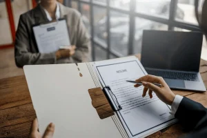 impressed recruiter signing the resume of the applicant