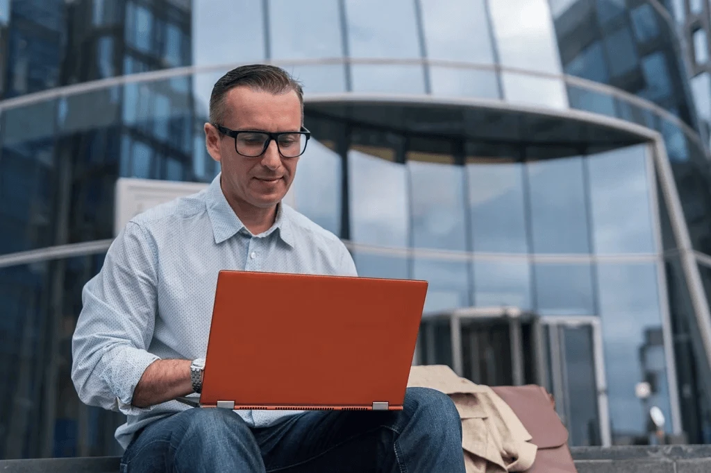 Job Seeker Optimizing His Resume On A Laptop